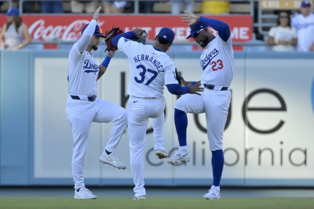 Andy Pages #44, Teoscar Hernandez #37 and Jason Heyward #23 of the Los Angeles Dodgers celebrate after the final out of the ninth inning against the Boston Red Sox at Dodger Stadium on July 21, 2024 in Los Angeles, California