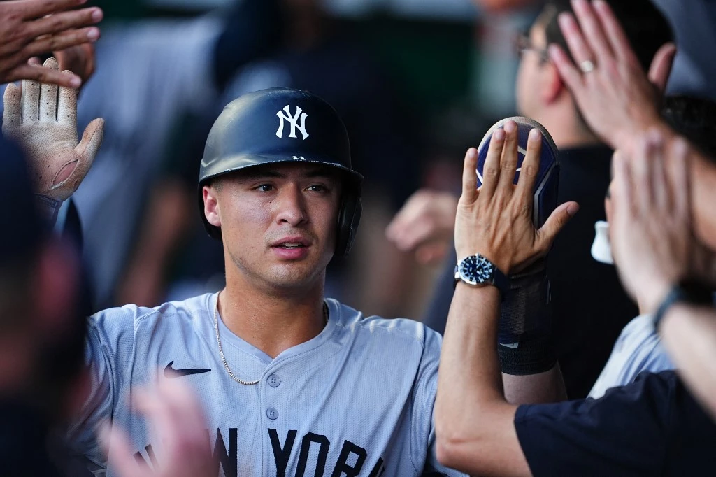 KANSAS CITY, MISSOURI - JUNE 12: Anthony Volpe #11 of the New York Yankees celebrates with teammates after scoring against the Kansas City Royals during the first inning at Kauffman Stadium on June 12, 2024 in Kansas City, Missouri.