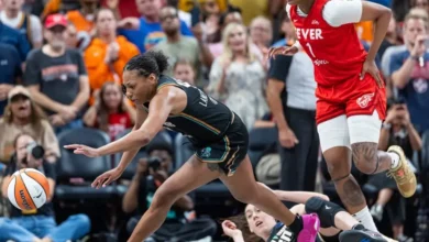 Betnijah Laney-Hamilton #44 of the New York Liberty reaches for a loose ball as NaLyssa Smith #1 of the Indiana Fever looks on during the second half at Gainbridge Fieldhouse on July 6, 2024 in Indianapolis, Indiana.