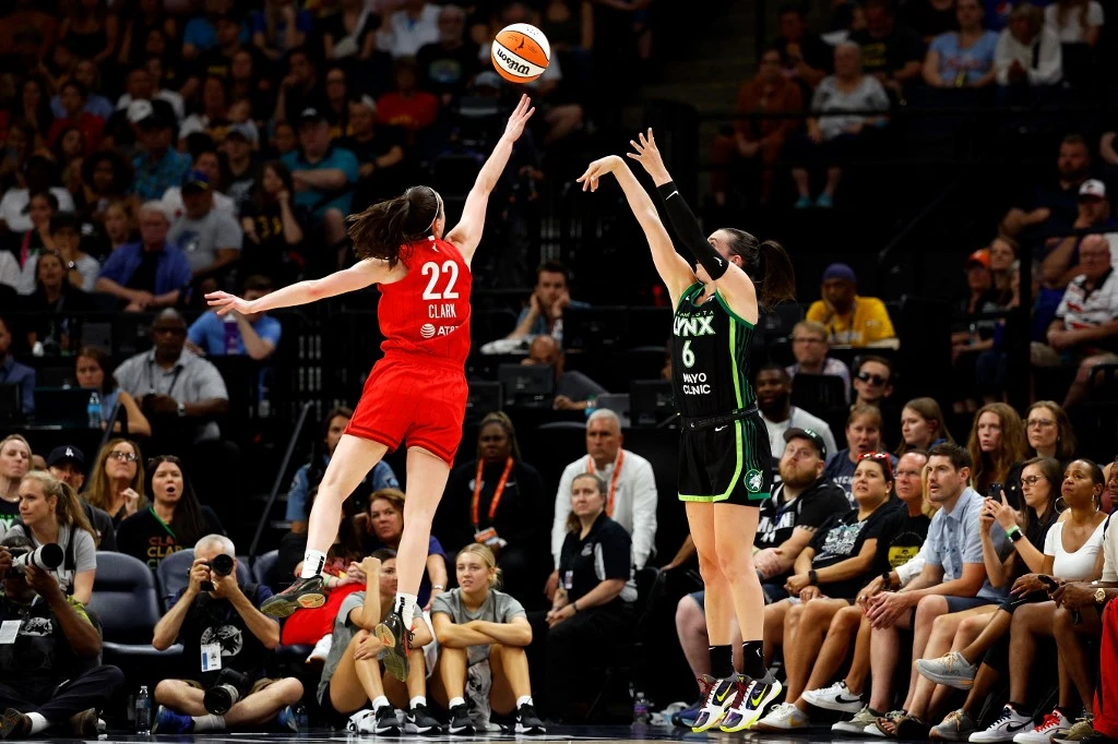 Bridget Carleton #6 of the Minnesota Lynx shoots the ball against Caitlin Clark #22 of the Indiana Fever in the third quarter at Target Center on July 14, 2024 in Minneapolis, Minnesota. The Fever defeated the Lynx 81-74