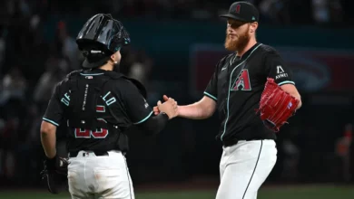 AJ Puk #33 and Adrian Del Castillo #25 of the Arizona Diamondbacks celebrate an 11-4 win against the Colorado Rockies at Chase Field on August 14, 2024 in Phoenix, Arizona.
